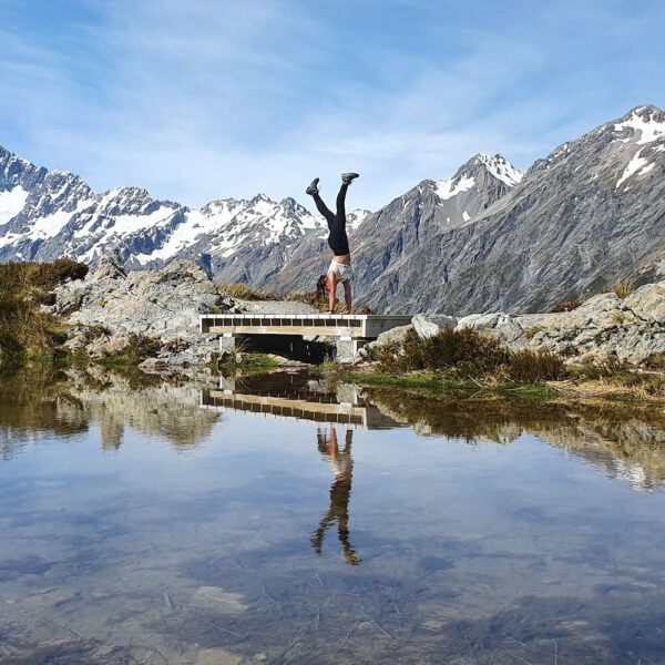 Girl doing a handstand. Mt Cook Stray Tour New Zealand Credit Alisha Pruisken